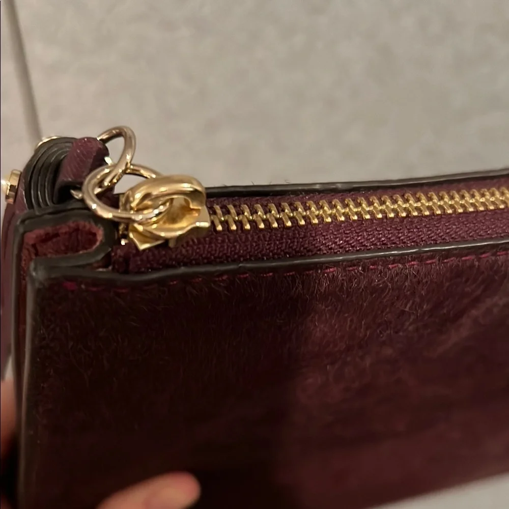 NWT kate spade burgundy suede pouch with gold logo
